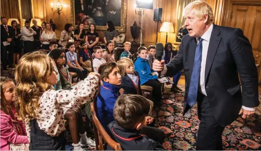  ??  ?? Any questions? Boris Johnson talks to children on a visit to No 10 yesterday to coincide with his spending announceme­nt