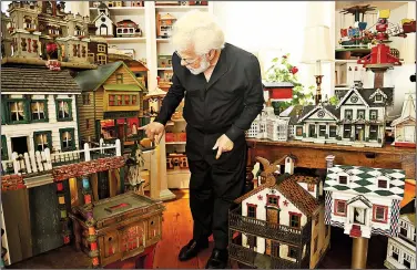  ?? TNS/Raleigh News & Observer/JULI LEONARD ?? At 70, Steven Burke has rescued and celebrated the work of a thousand mostly anonymous artists and is caretaker to a little universe of folk art houses. Here, Burke points out the details of corsets on sale through the window of a tiny dry goods store.