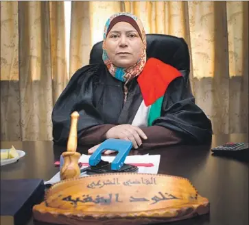  ?? Idle Wild Films ?? SHARIA LAW Judge Kholoud Al-Faqih at her desk in the documentar­y “The Judge” from Erika Cohn.