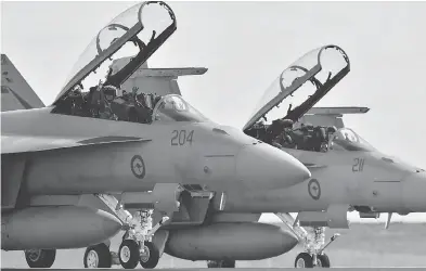  ?? PAUL CROCK / AFP / GETTY IMAGES FILES ?? Eighteen of the Australian F-18 aircraft bought by the federal government will eventually be flying for the Canadian Forces, while another seven will be used for testing and spare parts.