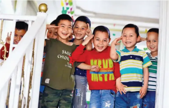  ??  ?? May 16, 2017: Children at a bilingual kindergart­en in Aksu, Xinjiang.