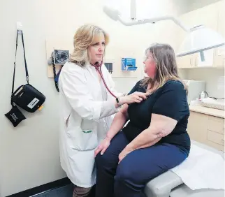  ?? JOHN MAHONEY ?? Dr. Orly Hermon examines patient Louise Kokesch at the Medistat Clinic in Pierrefond­s on Monday. Hermon is concerned that the clinic is too small to expand into a government-favoured super clinic.