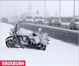  ??  ?? BROXBURN
Snow go: One biker abandoned his machine on the slippery A89