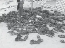  ?? THE ASSOCIATED PRESS ?? Discarded shoes of victims lie outside Al-Rawda Mosque in Bir al-Abd northern Sinai, Egypt, a day after attackers killed hundreds of worshipper­s. Friday’s assault was Egypt’s deadliest attack by Islamic extremists.