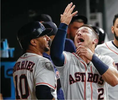  ?? Karen Warren / Staff photograph­er ?? The Astros’ offense returned Wednesday night as Yuli Gurriel, left, celebrates his two-run homer with a demonstrat­ive Alex Bregman during a three-run second inning. The Astros also scored three runs in the first and fifth.