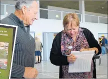  ??  ?? Marilyn Roberts signing her book for Stewart Rickard.