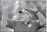  ?? AP/FILE PHOTO ?? Dolphins offensive line coach
Chris Foerster watches as players do drills during practice Aug. 16, 2016, in Davie, Fla. Foerster resigned Monday after a video appeared to show him snorting three lines of white powder at a desk.