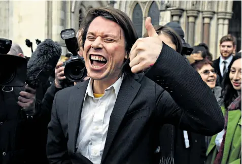  ??  ?? An elated Lauri Love and supporters emerge from the Court of Appeal yesterday after he won his case against extraditio­n