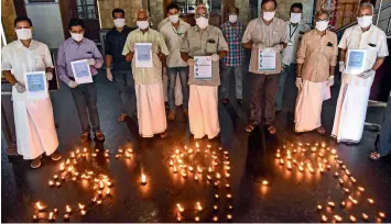  ?? PTI ?? IN SUPPORT OF PM’S CALL: People place lamps in a formation that reads 5.9.9 as they appeal to support the prime minister’s call to light 9 lamps at 9pm on April 5 to express unity against Covid-19, in Kochi, on Saturday. —