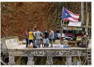  ?? DAVID SANTIAGO / MIAMI HERALD ?? Good Samaritans of the town of Isabela in Puerto Rico make a circle of prayer Friday with the residents of Rio Abajo in Utuado as efforts to recover from Hurricane Maria’s devastatio­n continue.