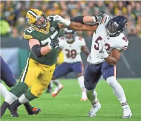  ?? BENNY SIEU / USA TODAY SPORTS ?? Packers tackle Bryan Bulaga faced a tough opponent in Bears linebacker Khalil Mack in the opener.