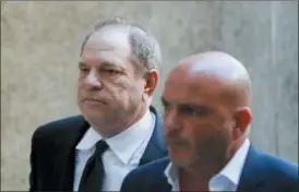  ?? JOHN MINCHILLO — THE ASSOCIATED PRESS ?? Harvey Weinstein, left, arrives to court, Monday in NewYork. Weinstein, who was previously indicted on charges involving two women, was due in court on Monday for arraignmen­t on charges alleging he committed a sex crime against a third woman.