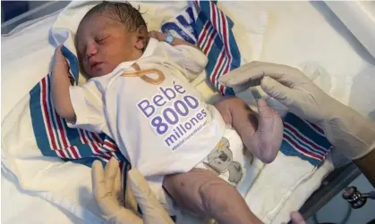  ?? Photograph: Orlando Barría/EPA ?? Damian, the first newborn registered in the Dominican Republic on 15 November, was chosen to symbolise the 8 billion milestone.