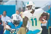  ?? CHRIS TROTMAN/GETTY IMAGES ?? DeVante Parker, right, is contending with an ankle injury, and did not practice on Wednesday.