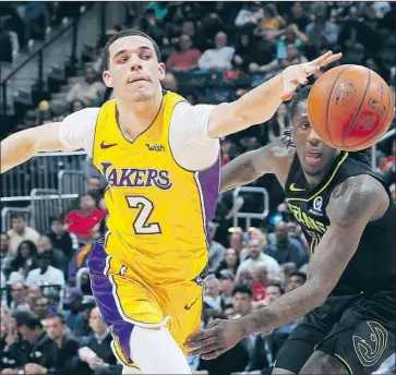  ?? Kevin C. Cox Getty Images ?? LAKERS’ LONZO BALL, losing the ball as he drives against Atlanta’s Taurean Prince in this game last season, is scheduled to play in his first preseason game Wednesday after recovering from knee surgery in July.