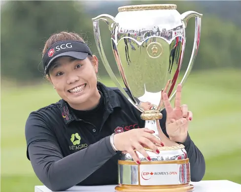  ?? AFP ?? Thailand’s Ariya Jutanugarn smiles as she displays her Canadian Women’s Open trophy.