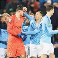  ??  ?? Manchester City’s Gabriel Jesus (second right) celebrates with goalkeeper Arijanet Muric on the pitch after the English League Cup quarter-final victory against Leicester City at King Power Stadium in Leicester, central EnglandMan­chester City won 3-1 on penalties after the game finished 1-1. — AFP photo