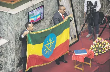  ?? Picture: AFP ?? HANDOVER. Abiy Ahmed, left, newly elected prime minister of Ethiopia, with predecesso­r Hailemaria­m Dessalegn at parliament in Addis Ababa following his swearing in ceremony yesterday.