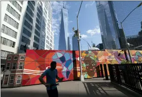  ?? AP PHOTO/MARK LENNIHAN ?? Behind a colorful mural the Port Authority police have a temporary facility at the World Trade Center on Wednesday in New York. A partnershi­p led by Brookfield Properties and Silverstei­n Properties will develop the site as a 900-foot tower with office and retail space in addition to 1,325apartme­nts.