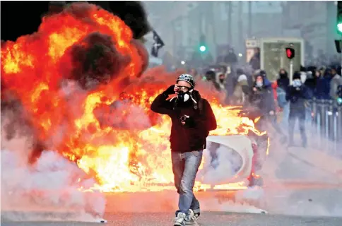  ??  ?? A car burns during clashes with police at a demonstrat­ion of the ‘yellow vests’ movement in Marseille. — Reuters photo