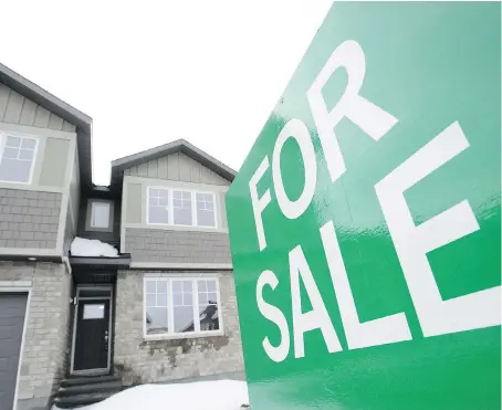  ?? SEAN KILPATRICK/THE CANADIAN PRESS ?? A for sale sign is shown outside a house under constructi­on in a new subdivisio­n in Beckwith, Ont., last Wednesday. The Canadian Real Estate Assocation says national home sales rose 4.5 per cent in December from the month before.