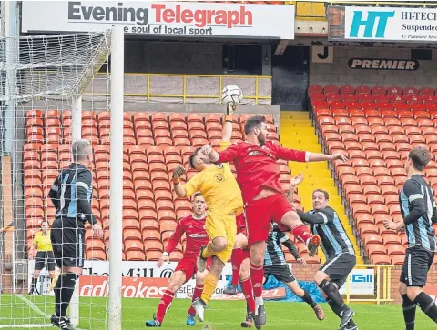  ??  ?? Action from the GA Cup Final between East Craigie and Carnoustie (red) at Tannadice. The Gowfers won on penalties.