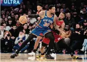  ?? Peter K. Afriyie/Associated Press ?? New York Knicks forward Julius Randle posts up as Miami Heat guard Terry Rozier defends during the first half last Saturday in New York.