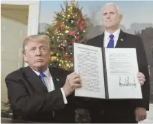  ?? AP PHOTO ?? EAGLE FLYING: President Trump and Vice President Pence display the order to move the U.S. Embassy in Israel.