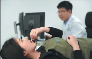  ??  ?? A patient ingests a capsule made by a company based in the Zhangjiang National Innovation Demonstrat­ion Zone.