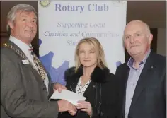  ??  ?? Seamus McDermott and Oliver Nixon, Dundalk Rotary Club make a presentati­on to Grace McArdle, Rape Crisis North East at a presentati­on by the Rotary Club to local groups.