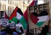  ?? ALBERTO PEZZALI — THE ASSOCIATED PRESS ?? Protester hold flags and placards as they take part in a pro-Palestinia­n demonstrat­ion as they wend their way along Whitehall in London, Saturday.