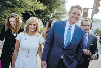  ??  ?? Arizona Sen. Jeff Flake, foreground, is accompanie­d by his wife, Cheryl Flake, in Washington, D.C., after announcing that he won’t seek re-election in 2018.