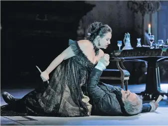  ??  ?? Sonya Yoncheva as Floria Tosca threatens to stab Zeljko Lucic as Scarpia in a dress rehearsal for the Met’s new production of Puccini's opera Tosca. Sir David McVicar’s production opens at the Metropolit­an Opera tonight, and will be shown in movie...