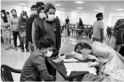  ?? PHOTO: PTI ?? Indian nationals who were airlifted from coronaviru­s-hit Hubei province of China undergo screening at a quarantine facility set by up ITBP in New Delhi