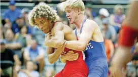  ?? [IAN MAULE/TULSA WORLD] ?? Elgin’s Jacob Butler attempts to escape from Perry’s Riley Cinnamon during their All-State wrestling match at Tulsa’s Charles Page High School on Wednesday.