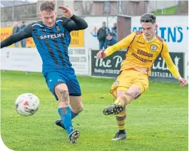  ??  ?? Liam Taylor (Forres) fires in a cross, despite the attention of Huntly’s Bradley Manson.