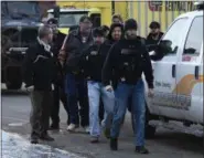  ?? AP PHOTO/MATT MARTON ?? Employees are escorted from the scene of a shooting at a manufactur­ing company Friday in Aurora, Ill, that police said left several people dead and several police officers wounded.