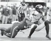  ?? TONY GUTIERREZ/AP ?? Florida’s David Reese, left, stops Michigan’s Kekoa Crawford.