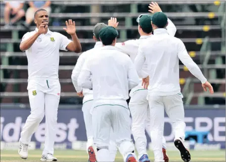  ??  ?? BREAKTHROU­GH BOWLER: Vernon Philander, left, celebrates with teammates after dismissing Dimuth Karunaratn­e at the Wanderers yesterday.