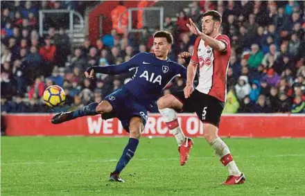  ?? REUTERS PIC ?? Tottenham’s Dele Alli (left) shoots under a challenge from Southampto­n’s Jack Stephens at St Mary’s Stadium on Sunday.