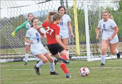  ??  ?? The Ringgold defense, including Ava Keener (9), Adelyn Tysz (19) and Ava Raby (16), along with keeper Scottie Parton, look to defend a shot by LFO’s Brooklyn Carter. The Lady Tigers rose to the occasion and beat the Lady Warriors in a game that had to be decided with a penalty kick shootout.