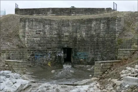  ?? TONY DEJAK — THE ASSOCIATED PRESS ?? The dam holding back the water for Horseshoe Lake is shown, Dec. 7, 2021, in Cleveland Heights. A pair of high-hazard dams built in the mid-1800s near Cleveland are among those in need of major repair. Upper Shaker Lake, commonly known as Horseshoe Lake, was drained as a precaution after it developed sinkholes and cracks.