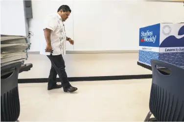  ?? Brett Coomer / Houston Chronicle ?? Richard Carranza, Houston Independen­t School District superinten­dent, walks through a flood-hit classroom. The delayed school year is to begin Monday, but some schools are too damaged to open.