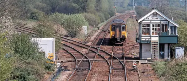  ??  ?? Whitlingha­m Junction signal box and the semaphore signalling were living on borrowed time when viewed on April 28 2000. The large grey cabin on the left is evidence of preparator­y work. After checking that 150235 (the 1345 LowestoftN­orwich) has a tail lamp, the signalman will send a Train Out of Section signal to Brundall (bell code 2-1). All these routes are now TCB.