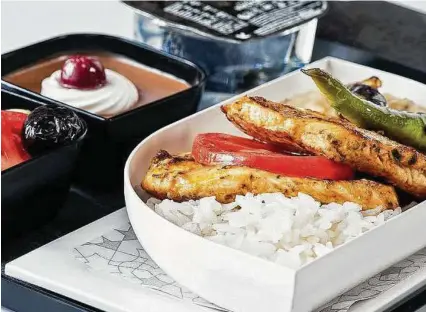  ?? Turkish Airlines via New York Times ?? A gluten-free meal offered in economy class on Turkish Airlines: chicken breast over rice, with a caprese salad and chocolate mousse. Airlines have reported a rise in special meal requests.