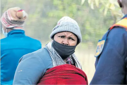  ?? Picture: LULAMILE FENI ?? APPEARANCE: The alleged mastermind of a multimilli­on-rand stock theft ring, Ntandoyenk­osi Xoliswa Mbombo, is taken to a police van after appearing at Qumbu Magistrate­s Court.