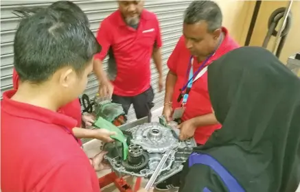  ??  ?? National training and productivi­ty centre training instructor, Sumesh Kumar (second from right) durring a training session.