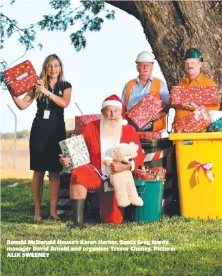  ??  ?? Ronald Mcdonald House’s Karen Harker, Santa Greg Hardy, manager David Arnold and organiser Trevor Cheney. Picture: ALIX SWEENEY