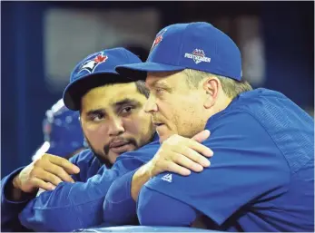  ?? DAN HAMILTON, USA TODAY SPORTS ?? The Blue Jays, with manager John Gibbons, right, and catcher Dioner Navarro, must win three in a row against the Royals to avoid eliminatio­n, which is what they did in the division series.