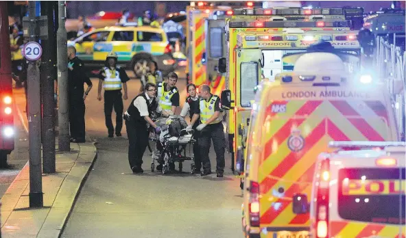  ?? — PHOTOS: GETTY IMAGES ?? Police and emergency workers attend to a person hurt in what police say was a terror attack in central London on Saturday.
